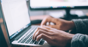 laptop and hands with notebook