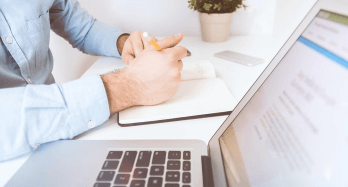 laptop and hands with notebook