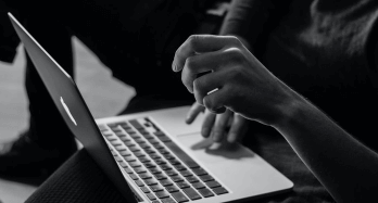 laptop and hands with notebook